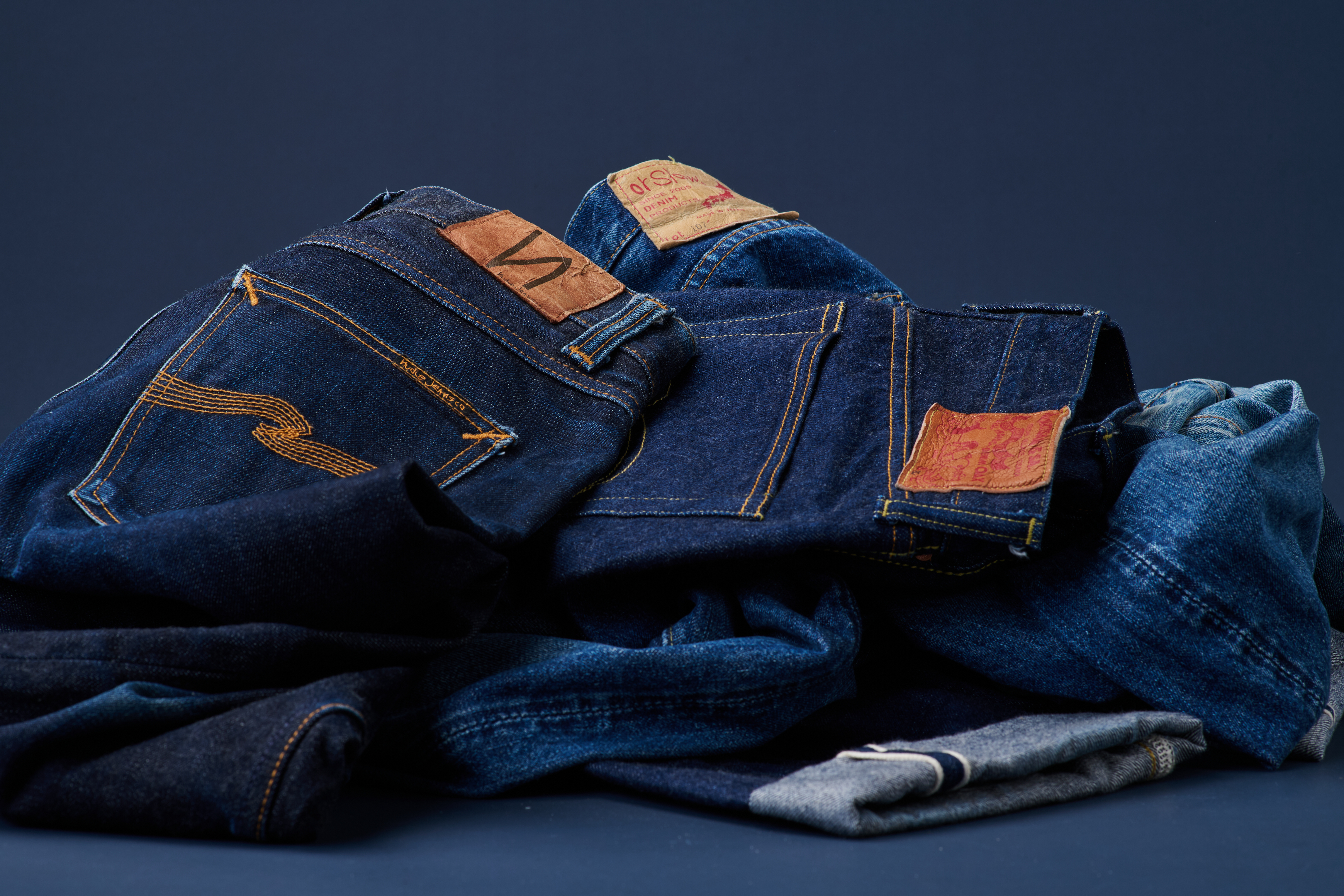 Vintage denim jeans with leather brand patches – fashion product photography